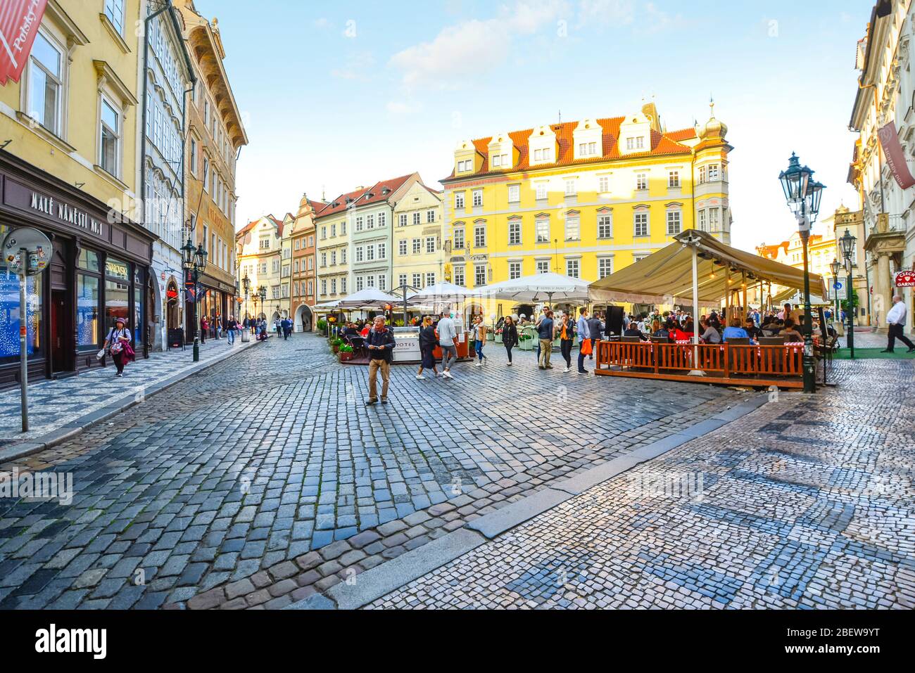 Touristen und Einheimische genießen einen geschäftigen Tag in den Geschäften und Cafés am Altstädter Ring im historischen Altstädter Ring von Prag, Tschechien Stockfoto