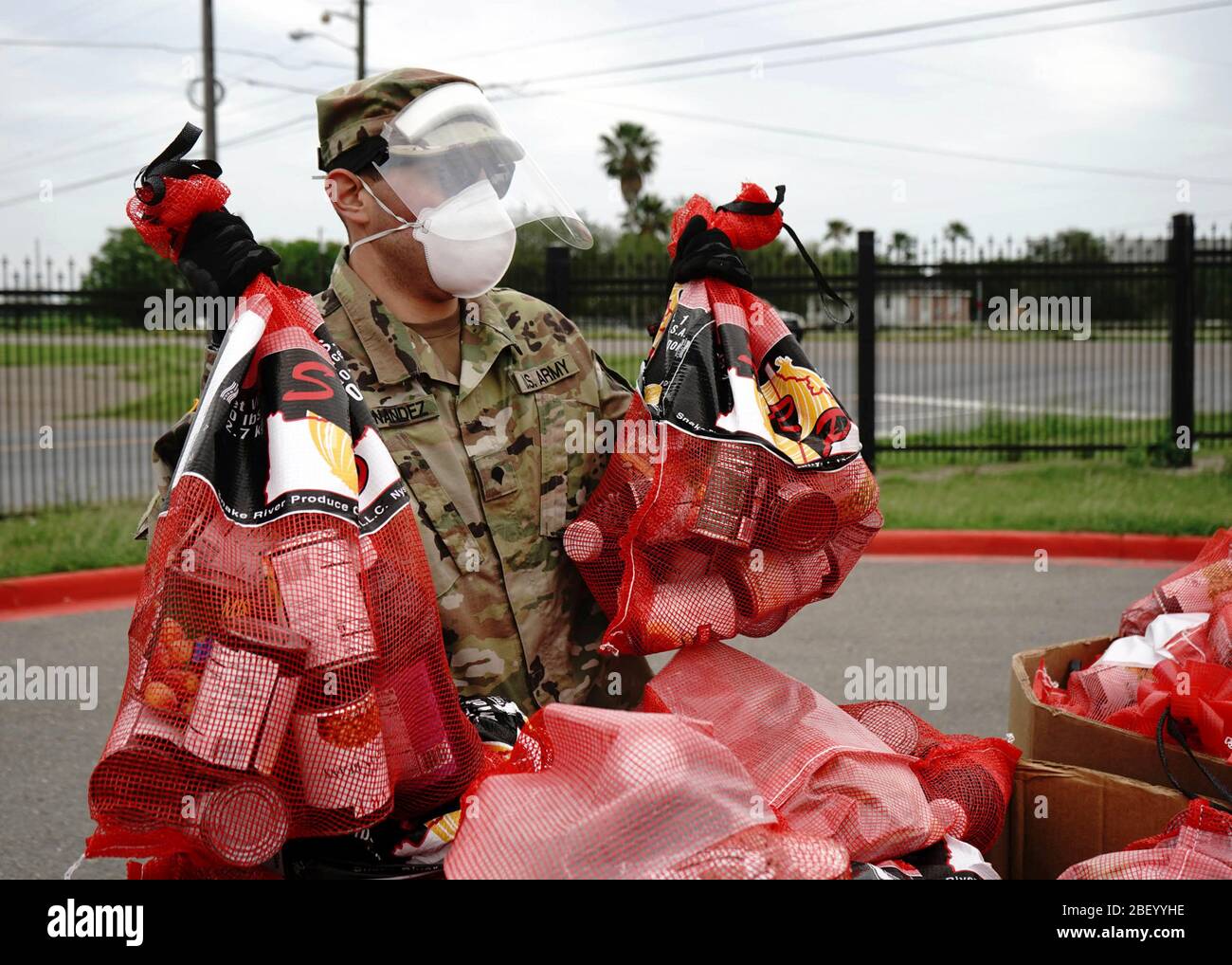 Texas National Guardsmen Spc. Juan Hernandez führt verpackte Konserven mit, um die COVID-19, Coronavirus Engpässe im Endowment Community Resource Center zu unterstützen 15. April 2020 in Edinburg, Texas. Stockfoto