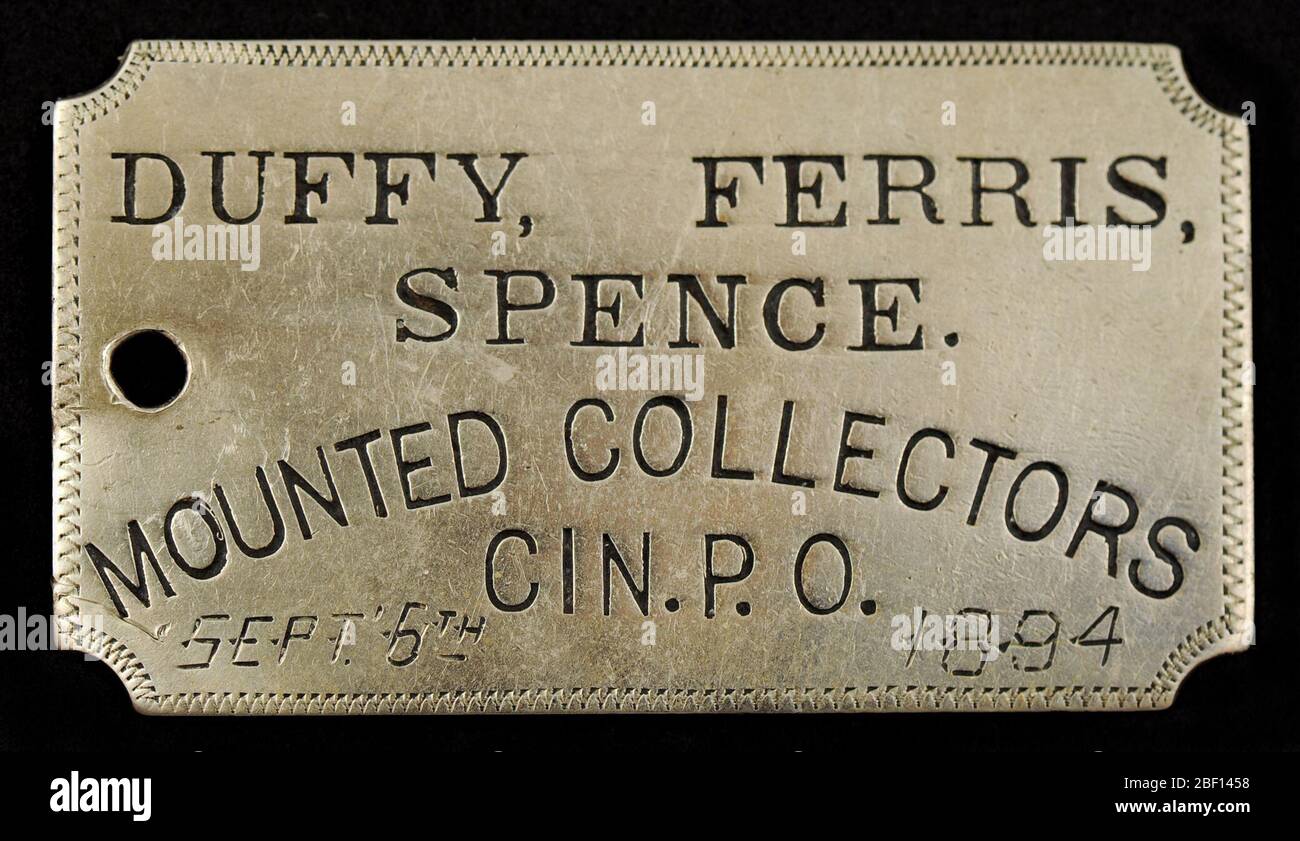 Cincinnati Ohio Owney Tag. Owney erhielt dieses rechteckige Metallschild, gekennzeichnet mit Duffy, Ferris und Spence, Mounted Collectors, Cincinnati, Post, während eines Besuchs in Cincinnati, Ohio. Der Tag enthält handgeschränke Markierungen des Datums, 6. September 1894. Das Tag wurde von G.G. erstellt Stockfoto