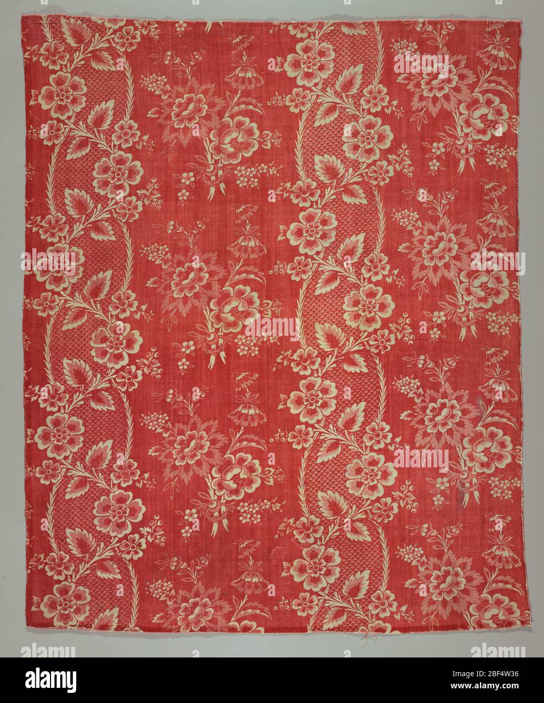 Textil. Geschwungene Streifen und Blumen im Feld. Zwei Rottöne. Stockfoto