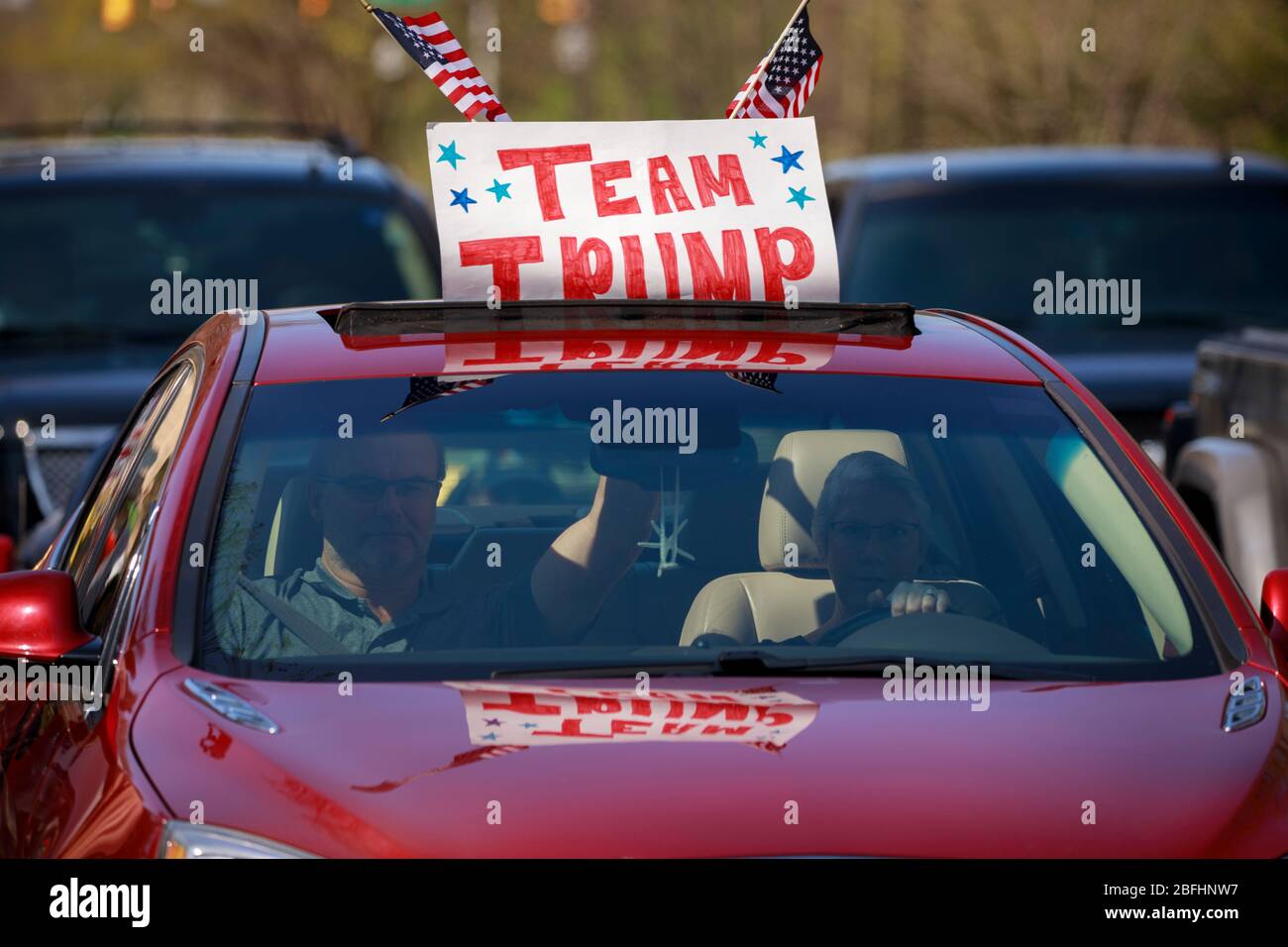 Trump-Anhänger in einem Auto schließen sich einem Protest an, während sie auf der Straße fahren.Demonstranten versammeln sich vor dem Herrenhaus des Gouverneurs Eric Holcomb in Indiana im Block 4700 der N. Meridian Street, um zu protestieren, was sie als "Regierungsüberreichungen" als Unternehmen beschreiben, Und Institutionen, weiterhin geschlossen werden während der Aufenthalt-at-Home-Ordnung, um die Ausbreitung von COVID-19 / Coronavirus im Staat zu bekämpfen. Der Protest wurde organisiert, nachdem die Demonstranten in Michigan Anfang der Woche protestierten. Ähnliche Proteste haben in den Vereinigten Staaten stattgefunden, da Facebook-Seiten und Websites mit ähnlichen Websites online aufgetaucht sind Stockfoto