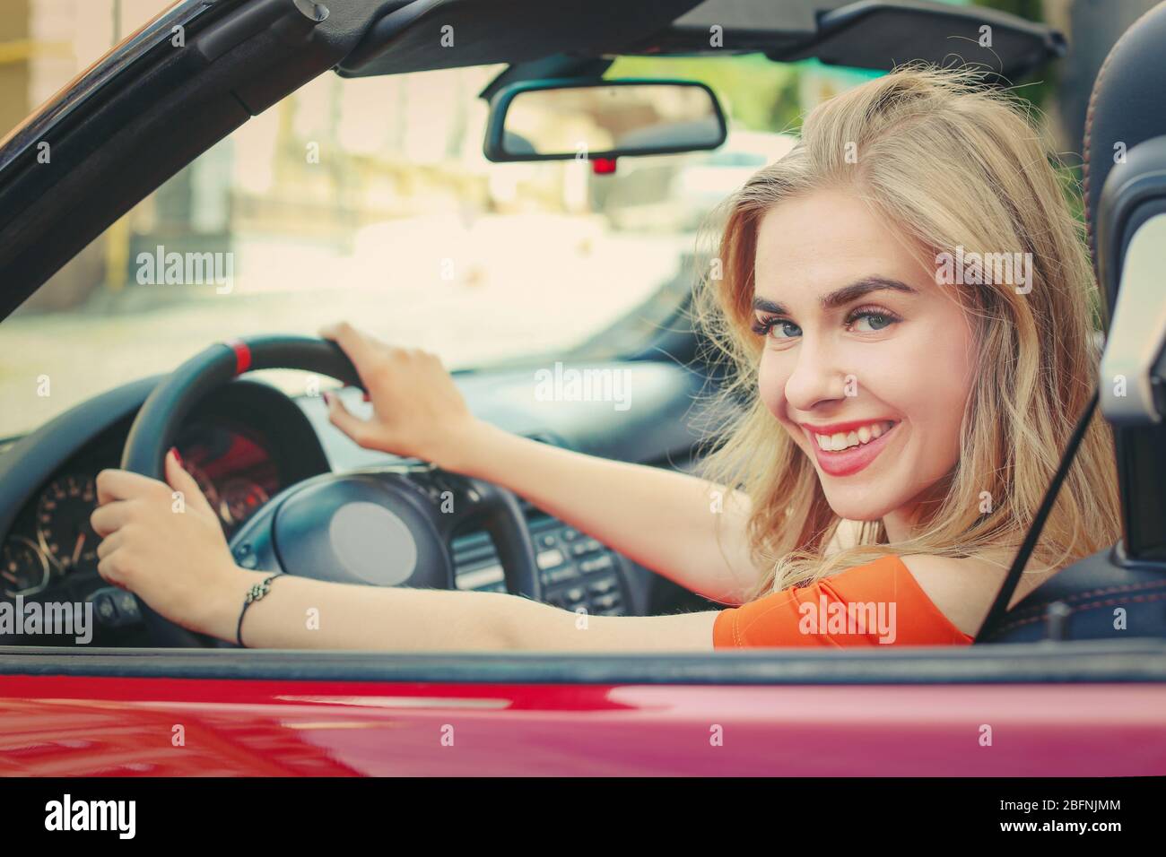 Schöne junge Frau im Auto Stockfoto