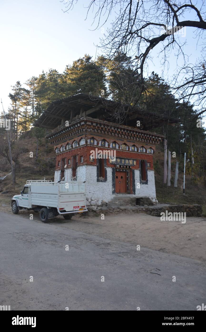 Historische religiöse Holz und Stein Struktur mit einem Gebetsrad, Bumthang, Bhutan. Stockfoto