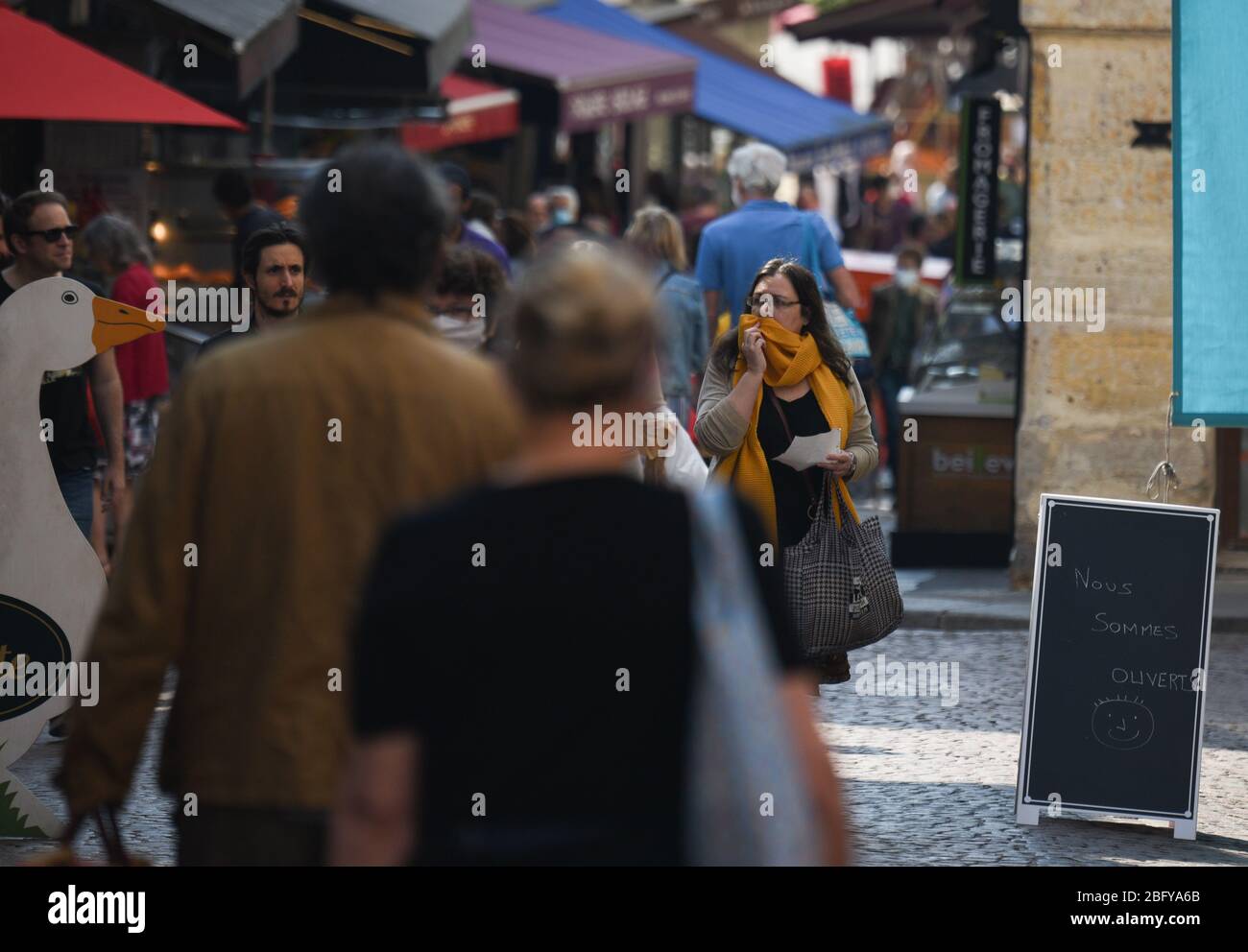 *** KEINE VERKÄUFE AN FRANZÖSISCHE MEDIEN ODER VERLAGE - RECHTE VORBEHALTEN *** 12. April 2020 - Paris, Frankreich: Pariser tragen Gesichtsmaskenladen in der Rue Mouffetard, einen Monat nach der Blockierung gegen den Ausbruch des Coronavirus. Man kann Leute sehen, die auf der Straße Schlange stehen, wenn sie auf Bäckereien, Lebensmittelgeschäfte oder Fischgeschäfte warten. Präsident Macron kündigte an, die Sperre am 11. Mai aufzuheben. Stockfoto