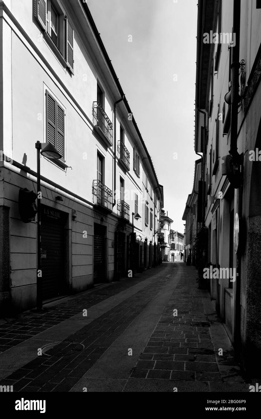 Die Stille und die Verwüstung in einer Stadt in der Nähe von Mailand, am sonntagmorgen, während Coronavirus. Leere Straße im Stadtzentrum, keine Leute, Geschäfte sind clos Stockfoto