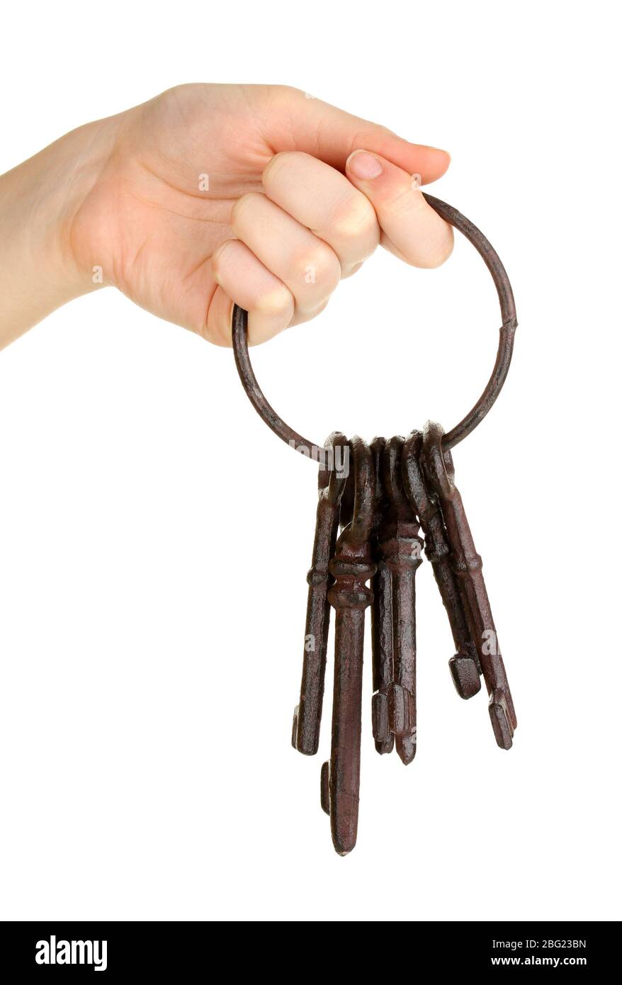 Ein Haufen alter Schlüssel in der Hand isoliert auf weiß Stockfoto