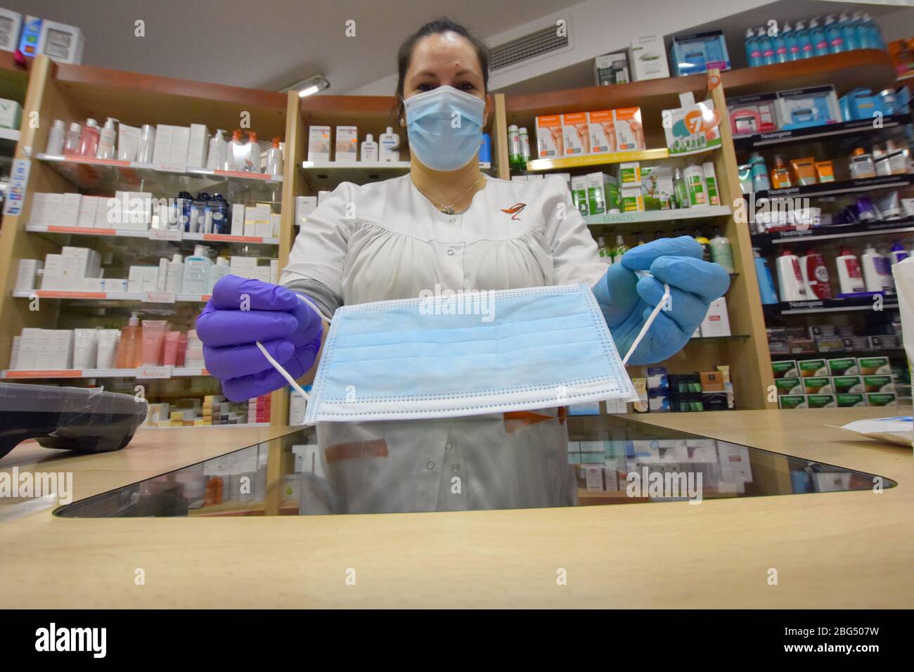 Ein Apotheker zeigt eine kostenlose OP-Maske, die die Regierung von Katalonien den Bürgern während der Coronavirus-Pandemie zur Verfügung gestellt hat.die Apotheken von Katalonien (Spanien) begannen heute, chirurgische Masken zu verteilen, um eine weitere Ansteckung aufgrund der Gesundheitskrise von Covid-19 zu verhindern, die die Regierung von Katalonien an die Bevölkerung schickt. Jeder Bürger erhält eine kostenlose Maske, die mit seinen Gesundheitskarten validiert wird, und wenn er eine zweite benötigt, muss der Bürger dafür bezahlen. Stockfoto