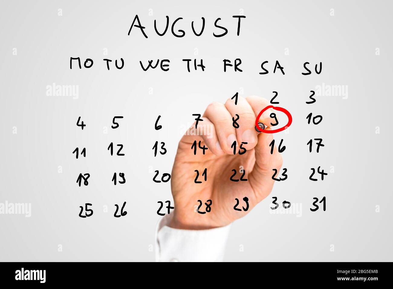 Männliche Hand zum 9. August - Internationaler Tag der indigenen Völker der Welt - auf virtuellem Kalender. Stockfoto