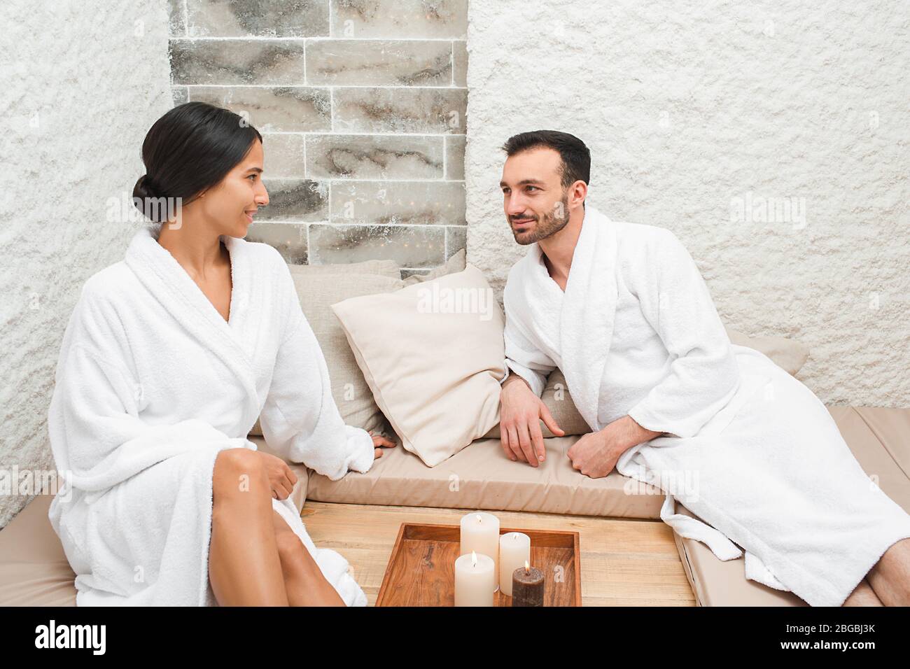 Gemischte Paare genießen Salzraumtherapie im Spa-Salon. Körperbehandlung im Salzraum Stockfoto