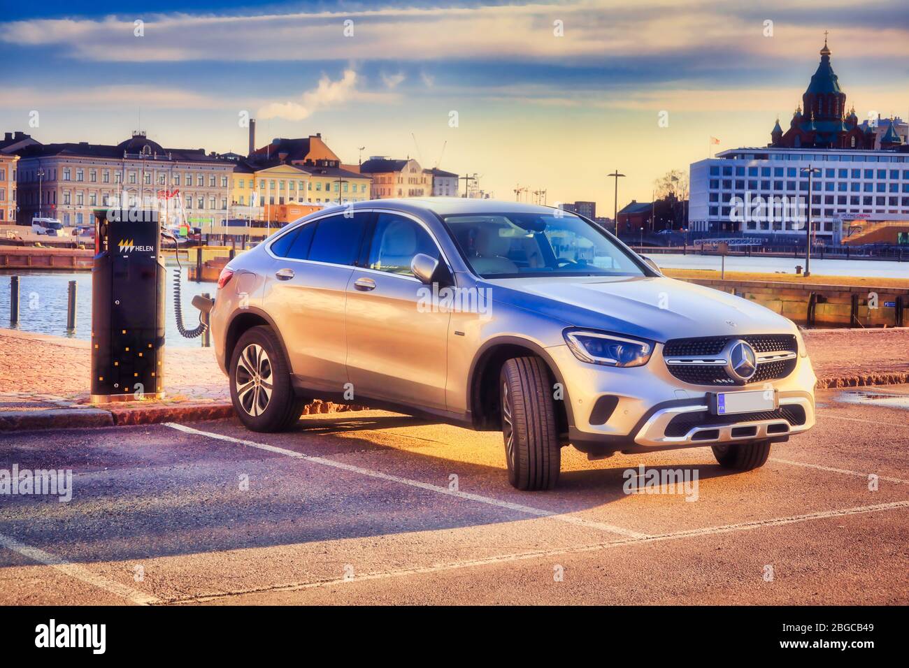 Das silberne Mercedes-Benz EQ Power Hybridauto wird an der Helen Vehicle Charging Point an der Strandpromenade in Helsinki, Finnland, aufgeladen. 18. April 2020. Stockfoto
