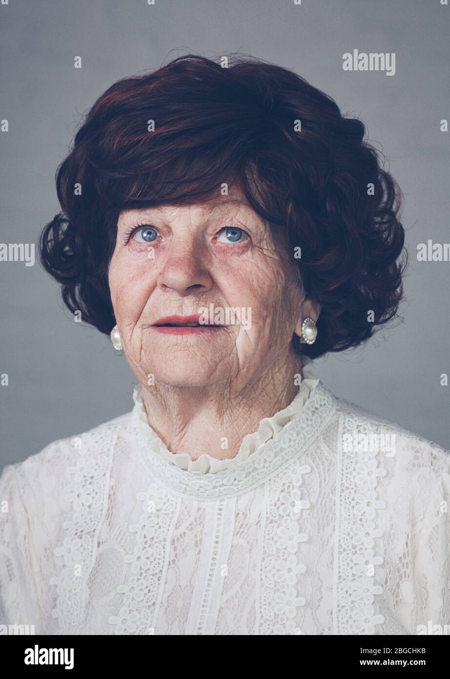 Porträt von schönen älteren erwachsenen Frau, die aufschaut, 80 Jahre alt Stockfoto