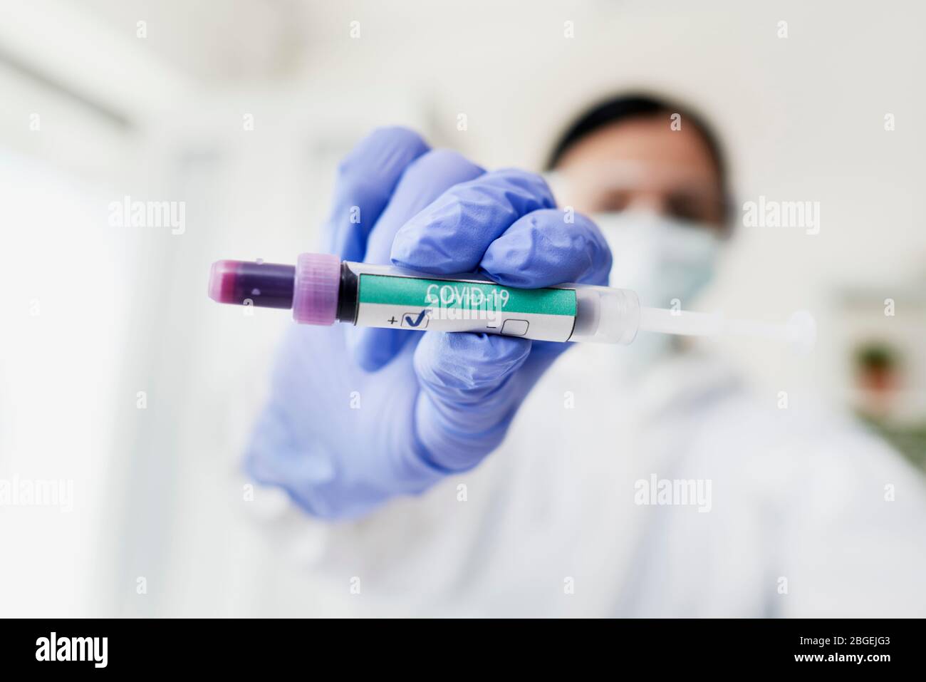 Techniker mit positivem Teströhrchen des Coronavirus Stockfoto
