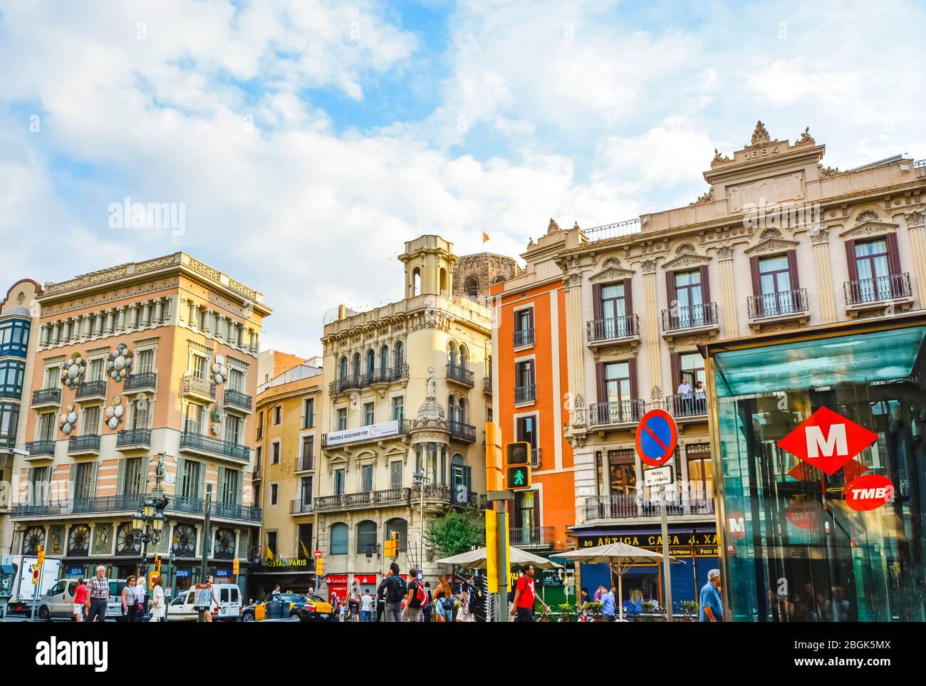 Eine bunte Reihe von Gebäuden mit Geschäften und Cafés unter einem blauen Himmel im touristischen Zentrum von Barcelona Spanien, auf der berühmten La Rambla Straße. Stockfoto