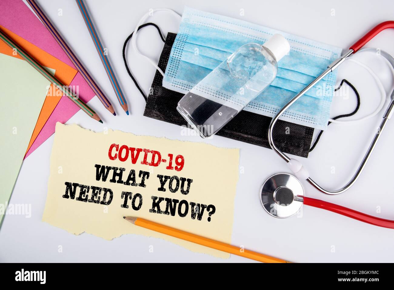 COVID-19. Was Sie Wissen Müssen. Informationen und Anweisungen. Schwarze und blaue Doctor Maske, Handdesinfektionsmittel und Stethoskop auf weißem Hintergrund Stockfoto