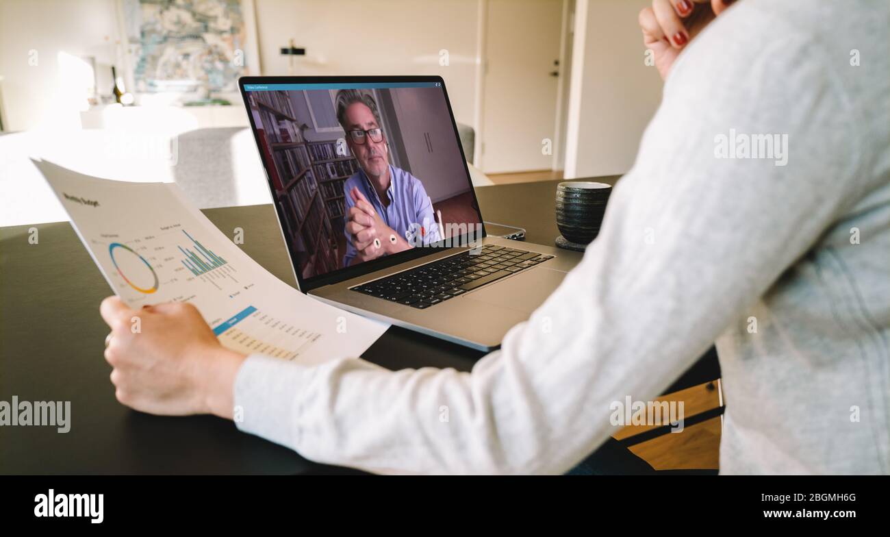 Geschäftspartner, die ein Notebook für ein Online-Meeting per Videoanruf verwenden. Geschäftsfrau, die von zu Hause aus mit Laptop Videoanrufe mit Geschäftspartnern führt. Stockfoto