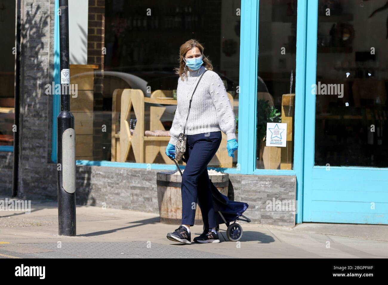 London, Großbritannien. 22. April 2020 - EINE Frau, die während der Sperrung des Coronavirus eine Gesichtsmaske in Nordlondon trägt. Die Öffentlichkeit wird gebeten, Gesichtsmasken in der Öffentlichkeit zu tragen, um die Verbreitung von COVID-19 zu stoppen. Kredit: Dinendra Haria/Alamy Live News Stockfoto