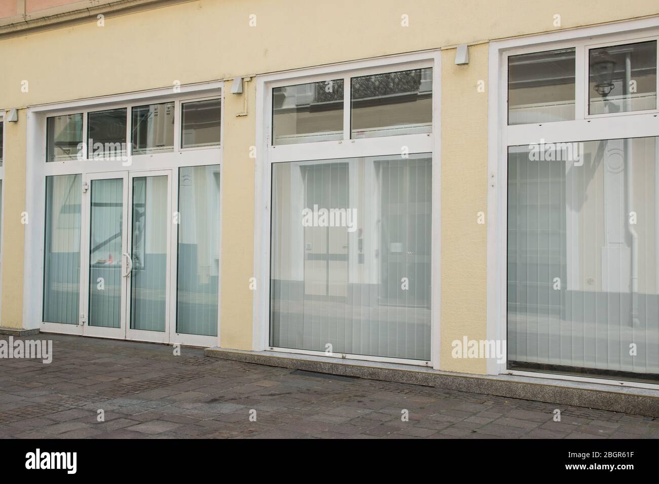Fassade Geschäft Vorderwand, gelbes Licht mit großer Tür und Fenster auf der Straße in der Stadt im Sommer sonnigen Tag. Stockfoto