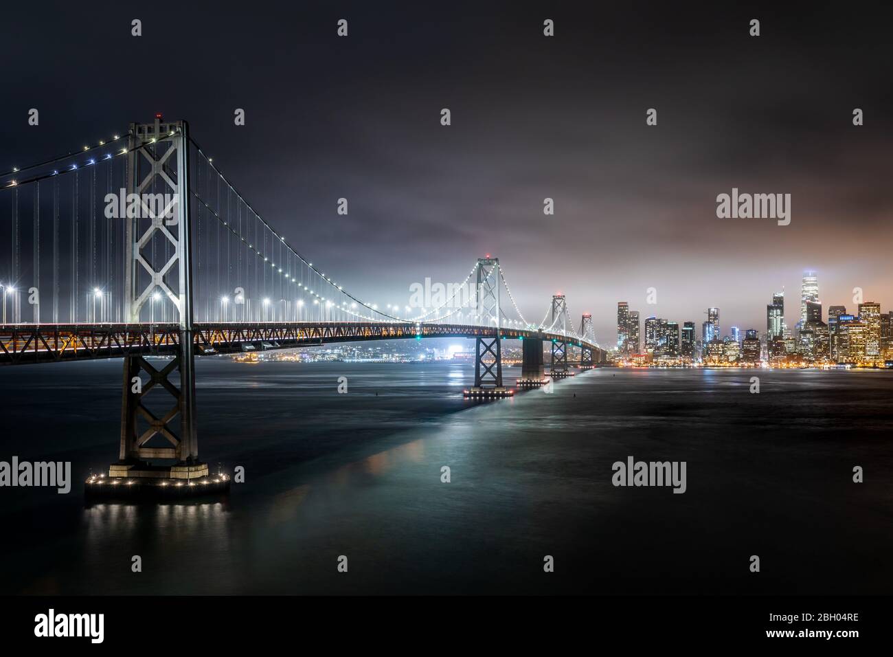 Nachtaufnahme der Skyline von San Francisco mit der Bucht Brücke im Vordergrund von Treasure Island aus gesehen Stockfoto