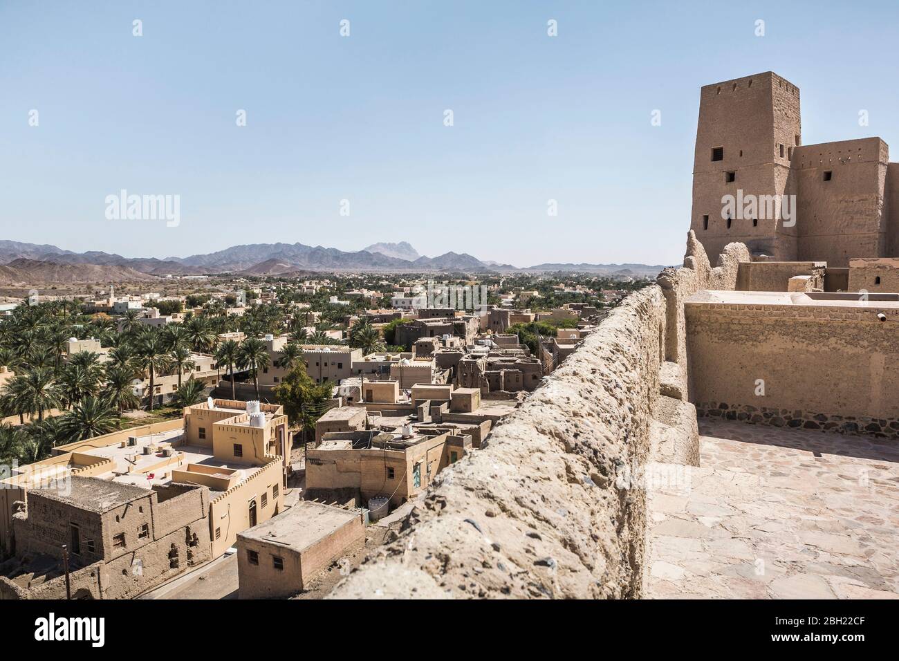 Oman, Al Batinah, Nakhal, Stadthäuser und entfernte Berge von Nakhal Fort gesehen Stockfoto
