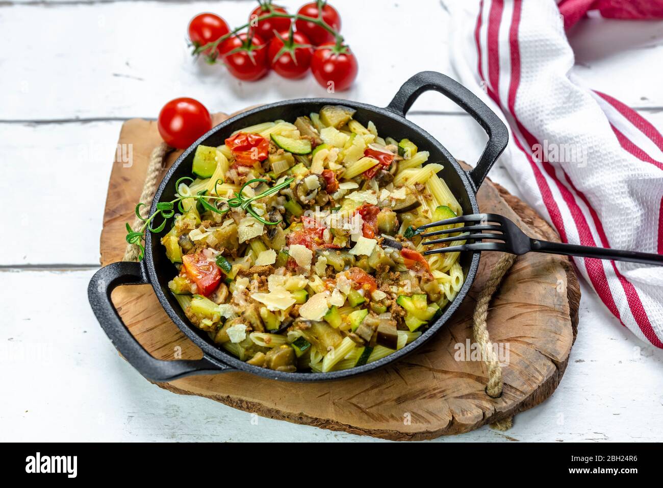 Pfanne mit vegetarischen Nudeln mit Zucchini, Auberginen, Tomaten und Parmesan Stockfoto