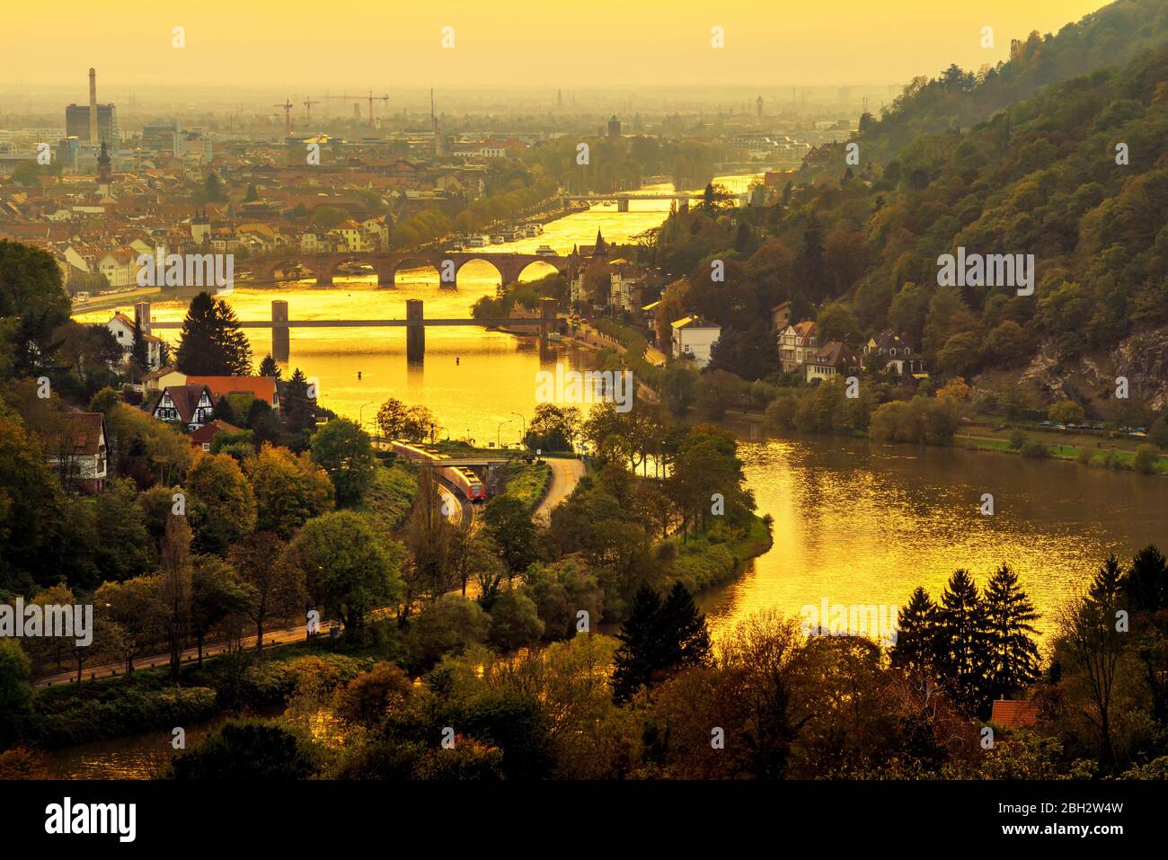 Heidelberg und der Neckar, Deutschland, bei einem goldenen Sonnenuntergang, von oben mit einem gelben Filter aufgenommen, um die schöne romantische Stimmung zu verbessern Stockfoto