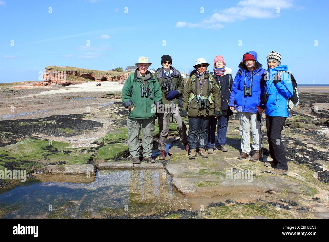 Natural History Group mit Hilbre Island als Kulisse, Wirral, Großbritannien Stockfoto