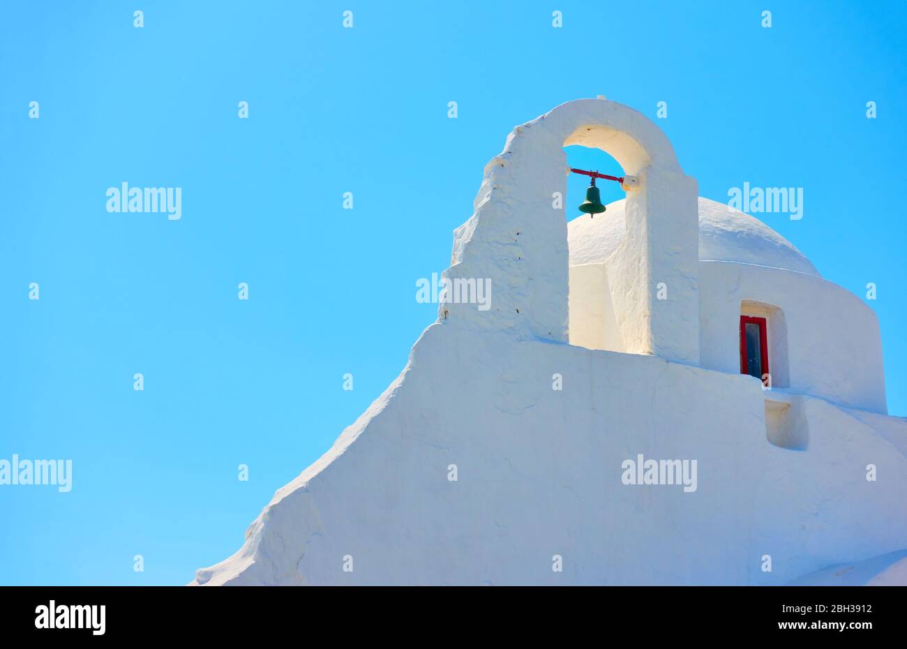 Kuppel und Glockenturm der Kirche Panagia Paraportiani in Mykonos Insel gegen den hellblauen Himmel, Griechenland Stockfoto