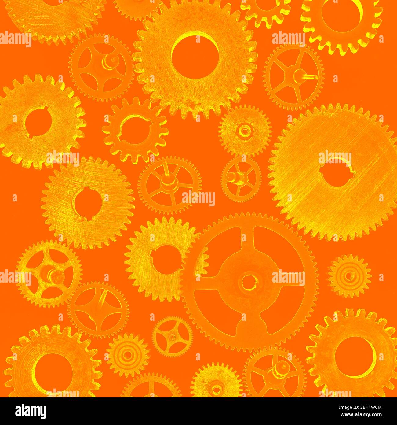 Abbildung von Zahnrädern auf orangefarbenem Hintergrund Stockfoto