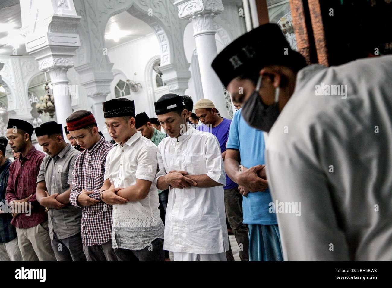 Banda Aceh, Indonesien. April 2020. Indonesische Muslime beten während der Ramadan-Nacht inmitten der Coronavirus-Pandemie in der Großen Moschee von Baiturrahman. Die indonesische Regierung ordnete die Schließung von Märkten und touristischen Destinationen an und forderte die Bewohner auf, öffentliche Versammlungen, einschließlich religiöser Aktivitäten, als Vorsichtsmaßnahme gegen die Verbreitung des Coronavirus zu vermeiden. Quelle: SOPA Images Limited/Alamy Live News Stockfoto