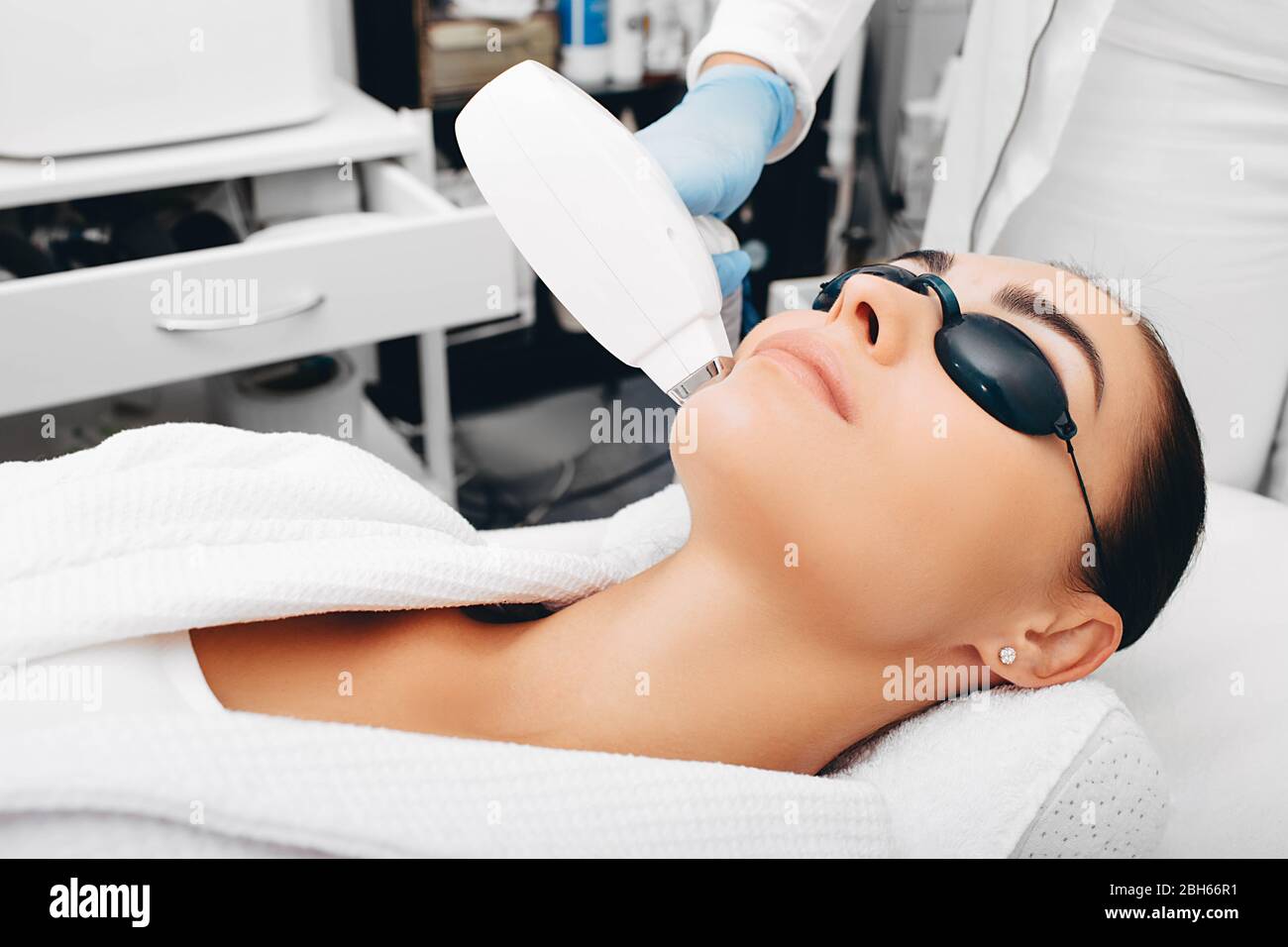 Kosmetikerin entfernt Gesichtshaar einer Brünette mit einem medizinischen  Laser. Laser-Haarentfernung. Nahaufnahme des Gesichts Stockfotografie -  Alamy