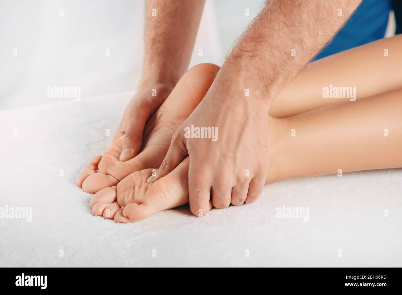 Reflexzonenmassage, Fußmassage. Massagen für Männer spezielle Punkte auf dem weiblichen Fuß. Entspannende Fußmassage Stockfoto