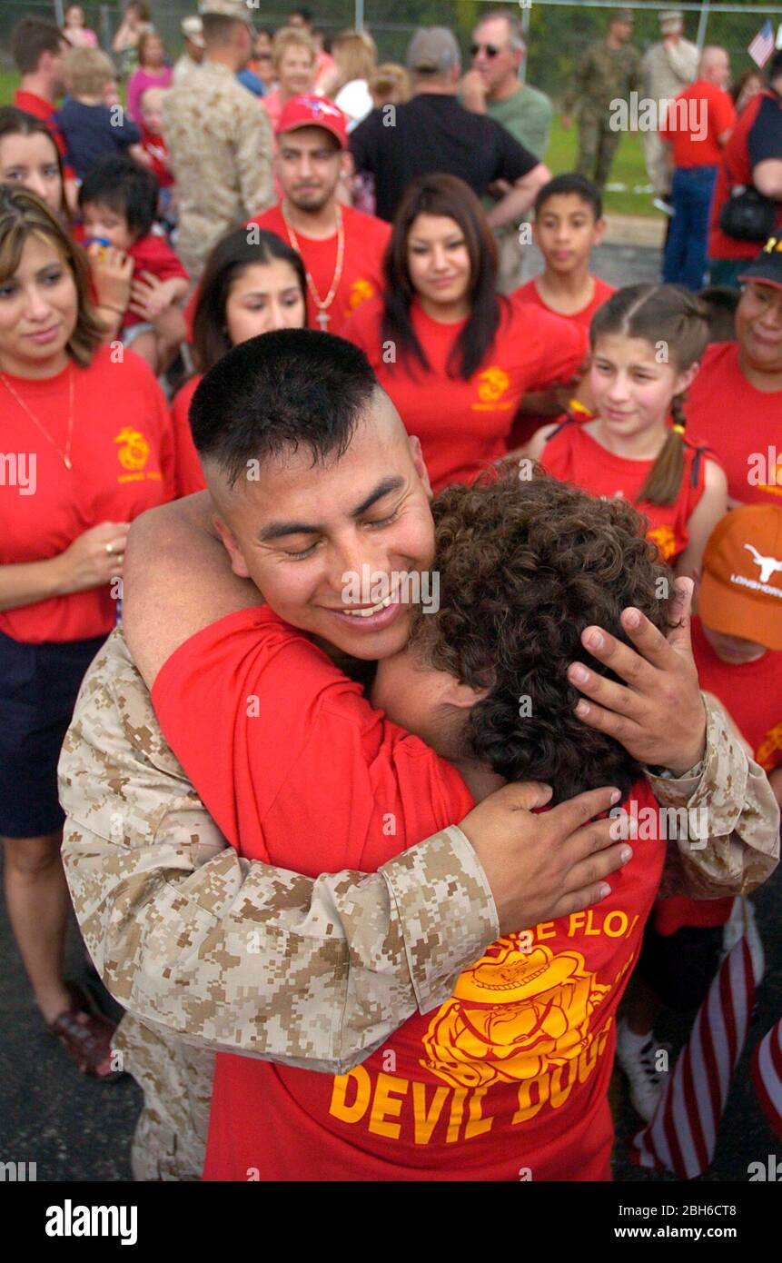 Austin, Texas, USA, 31. März 2005. Heimkehr-Feier für die 123. Weapons Company, United States Marine Reserve Unit aus Camp Mabry, Texas. Soldat umarmt seine Mutter, während der Rest seiner Großfamilie im Camp Mabry zuschaut. ©Bob Daemmrich Stockfoto