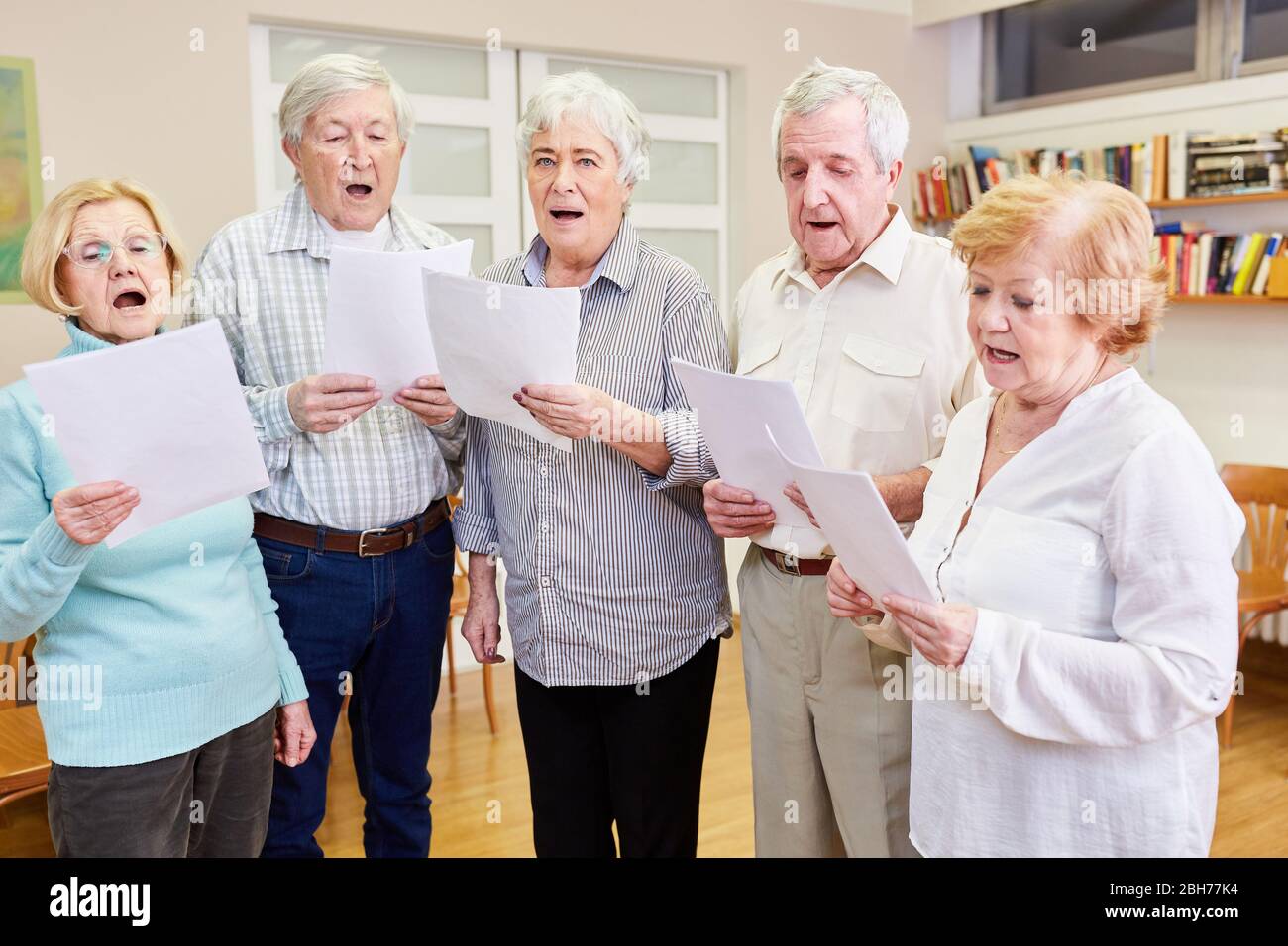 Alte Menschen als Sänger in einem Seniorenchor, der in einem Altersheim probt Stockfoto