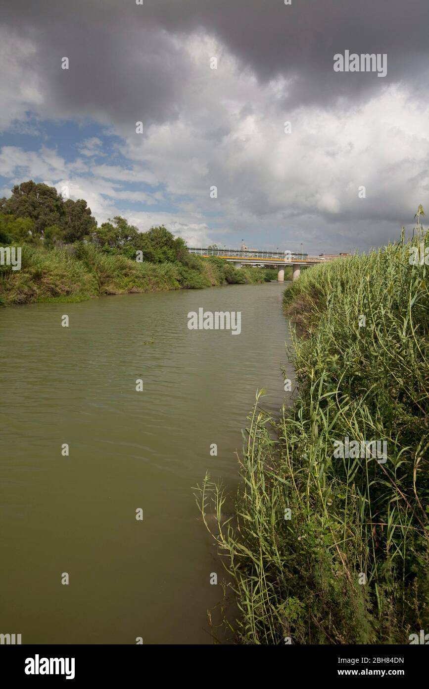 Brownsville, Texas USA, 7. Oktober 2009: Der Rio Grande River, die Grenze zwischen den Vereinigten Staaten und Mexiko, fließt in der Nähe der Innenstadt von Brownsville, mit Blick nach Westen mit Matamoros, Mexiko auf der linken Seite. Die Grenzmauer wird in Abschnitten auf der Seite der Vereinigten Staaten entlang einiger Teile des Flusses errichtet, wo Schmuggel herrscht. © Bob Daemmrich Stockfoto