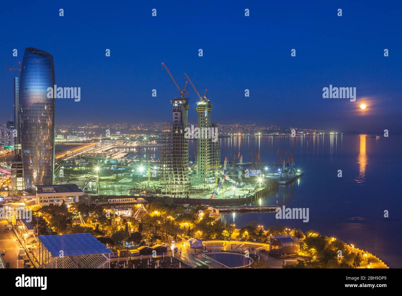 Aserbaidschan, Baku, hohen Winkel auf die Skyline des Hafens von Baku und Halbmond Gebäude im Bau mit mondaufgang Stockfoto