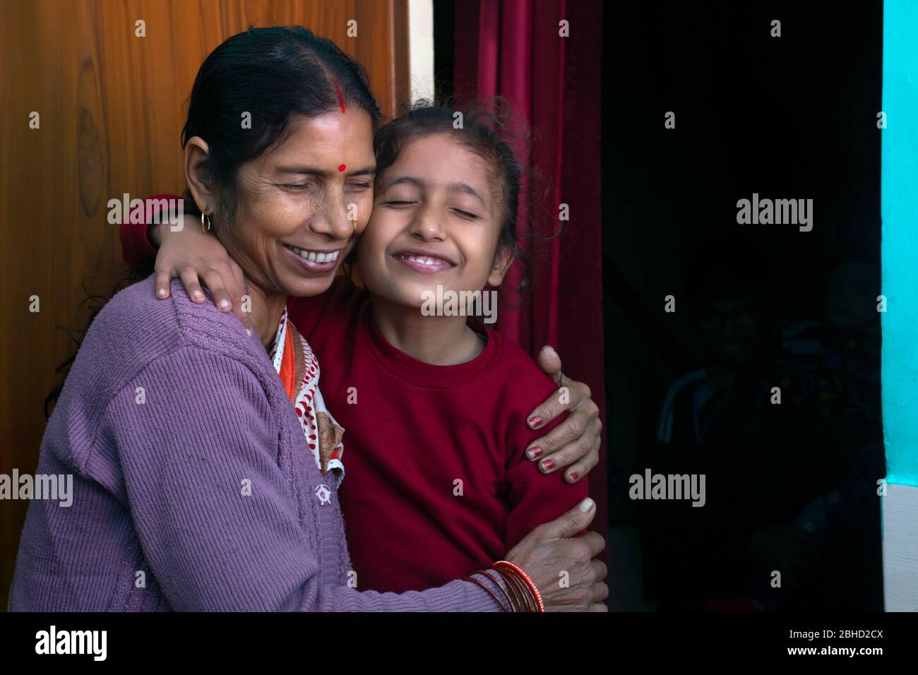 indische Großmutter und Enkelin umarmen sich gegenseitig, Indien Stockfoto