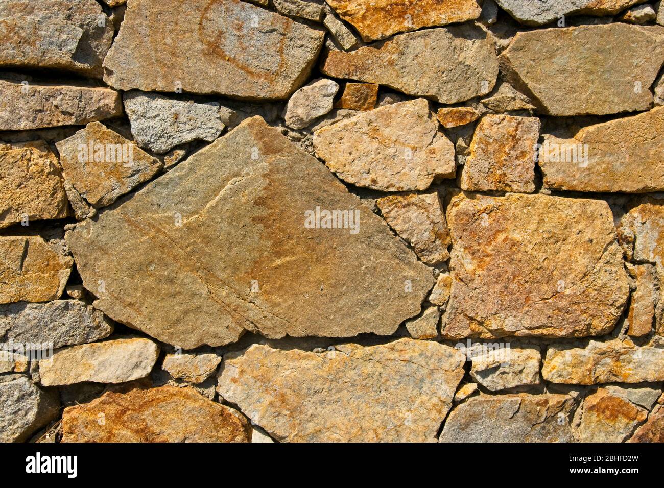 Textur einer Steinmauer. Strukturierter Hintergrund der Steinmauer des alten Schlosses. Steinwand als Hintergrund oder Textur. Teil einer Steinmauer, für Backg Stockfoto