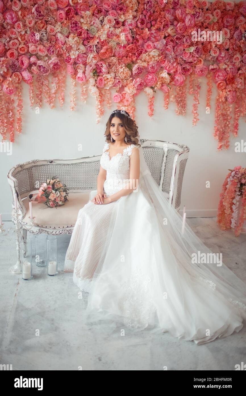 Eine Braut mit östlichem Aussehen in einem weißen Hochzeitskleid. Stockfoto