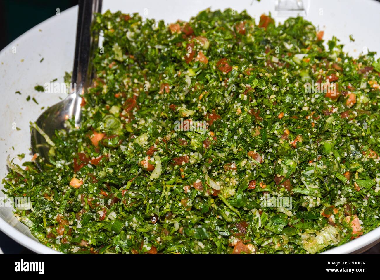 Tabbouleh ist ein levantiner vegetarischer Salat, der hauptsächlich aus fein gehackter Petersilie, mit Tomaten, Minze, Zwiebeln, Bulgur und gewürzt mit Olivenöl, lemo, hergestellt wird Stockfoto