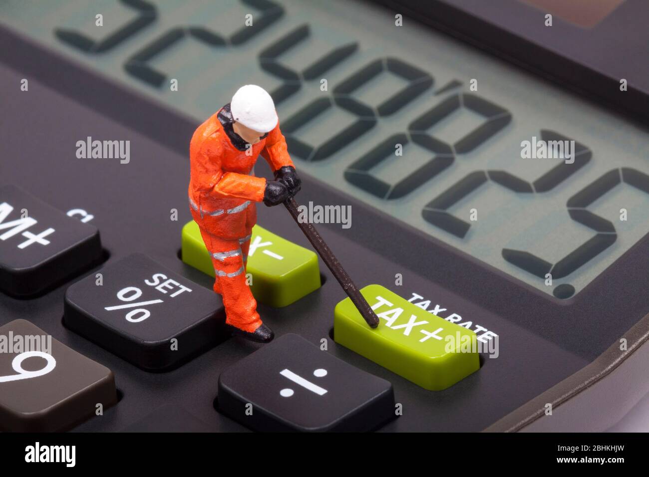 Konzeptuelles Bild eines Miniaturfigur Arbeiter neben Tasten markiert Steuer Stockfoto