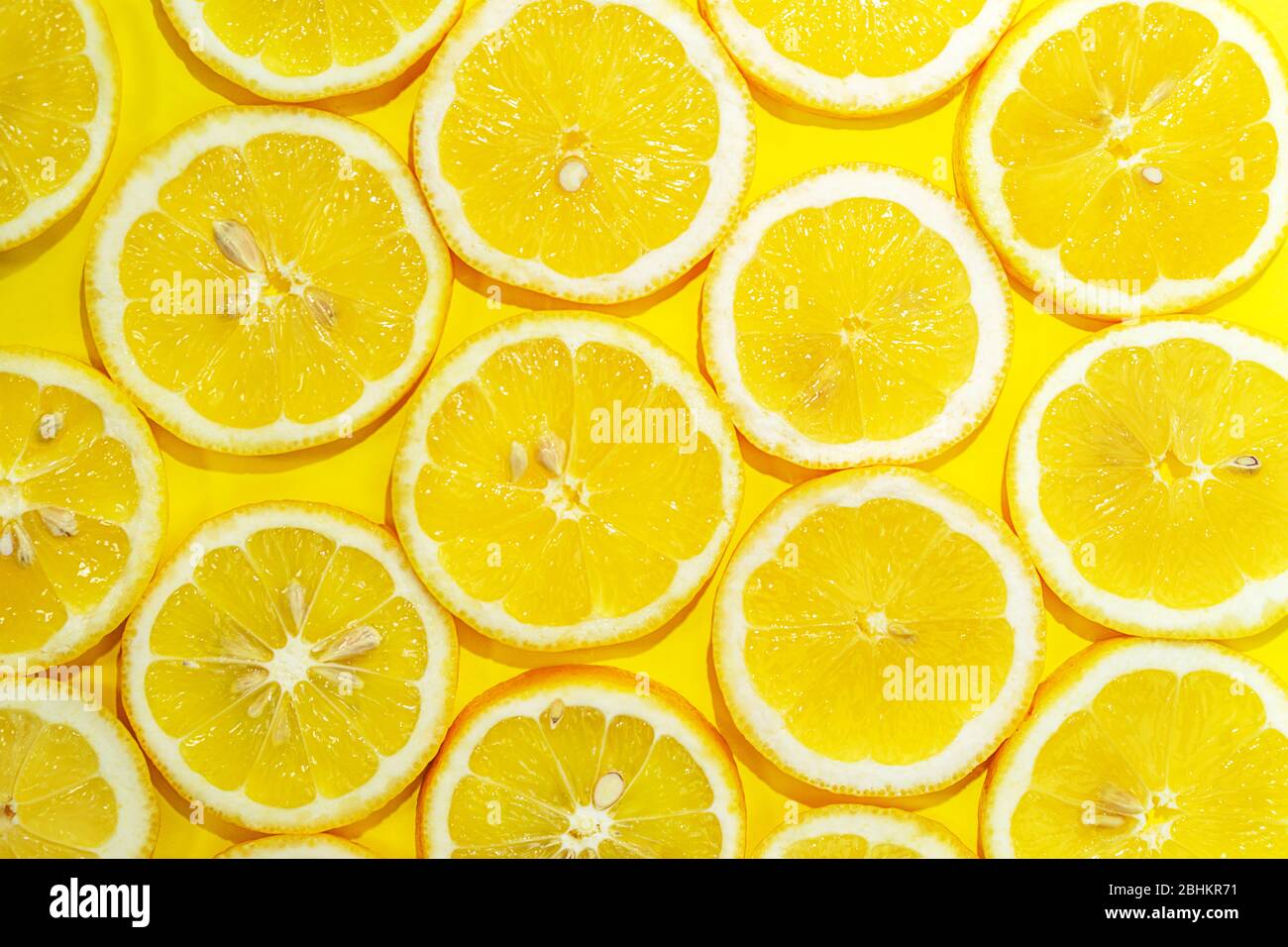 Zitrone in der Hälfte Hintergrund geschnitten. Ein Stück frische gelbe Zitrone Muster. Zitronenstücke in verschiedenen Größen. Stockfoto