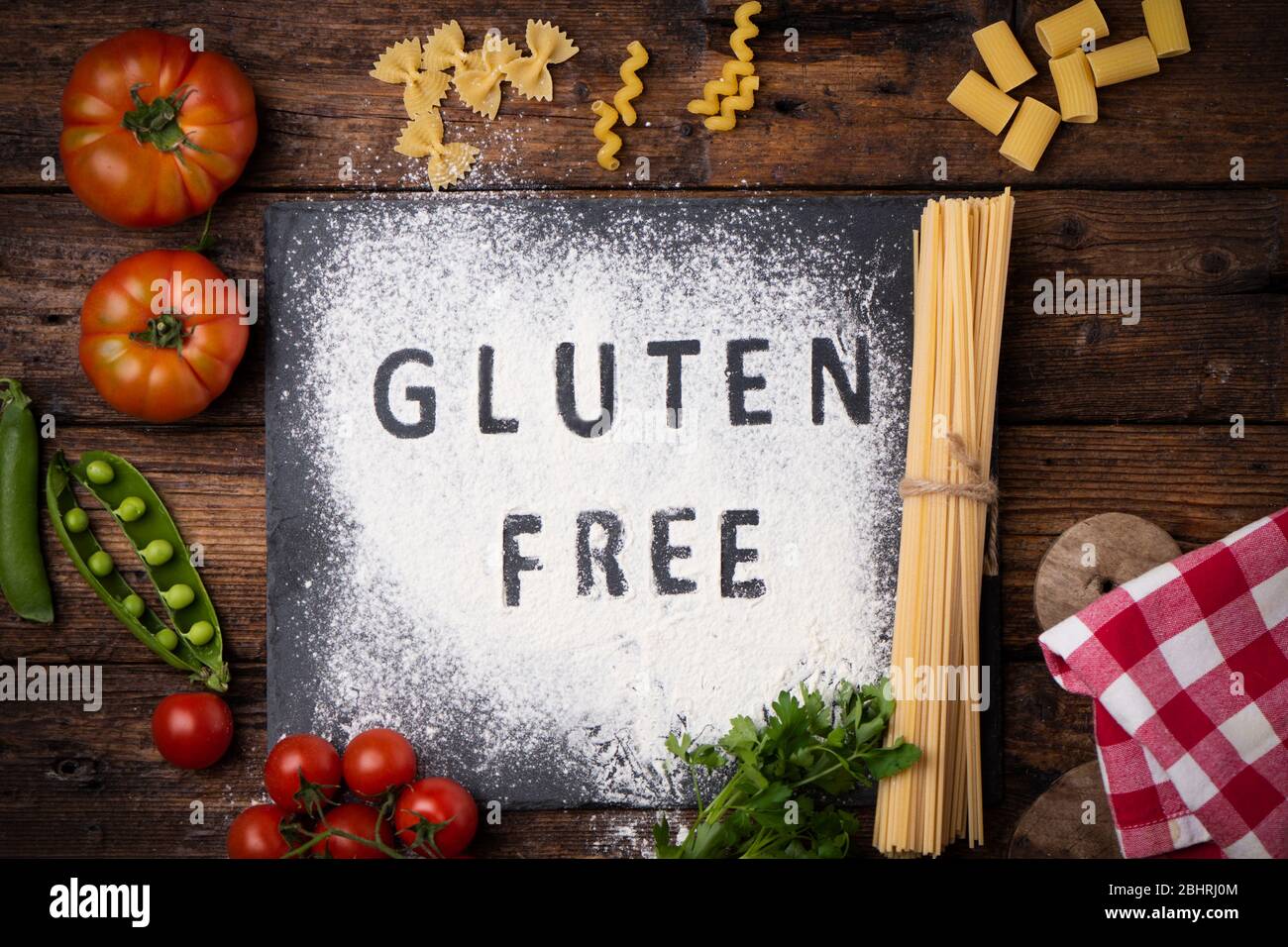 Glutenfreies Schild handgeschrieben auf einer Kreidetafel, umgeben von Zutaten aus der Nähe Stockfoto