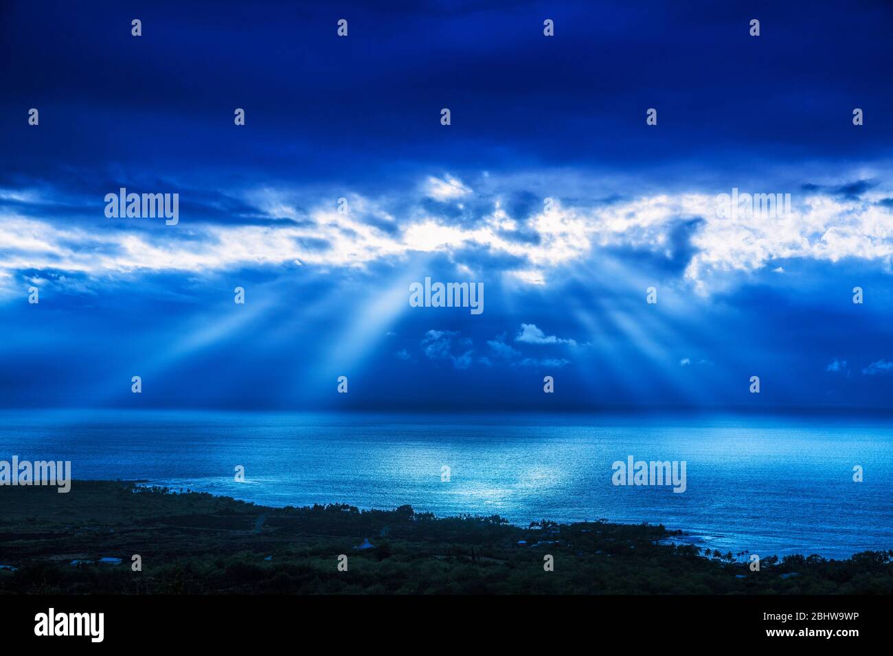 Tag für Nacht die Hand Gottes leuchtet durch Wolken über dem Pazifischen Ozean in Süd Kona, Hawaii. Stockfoto