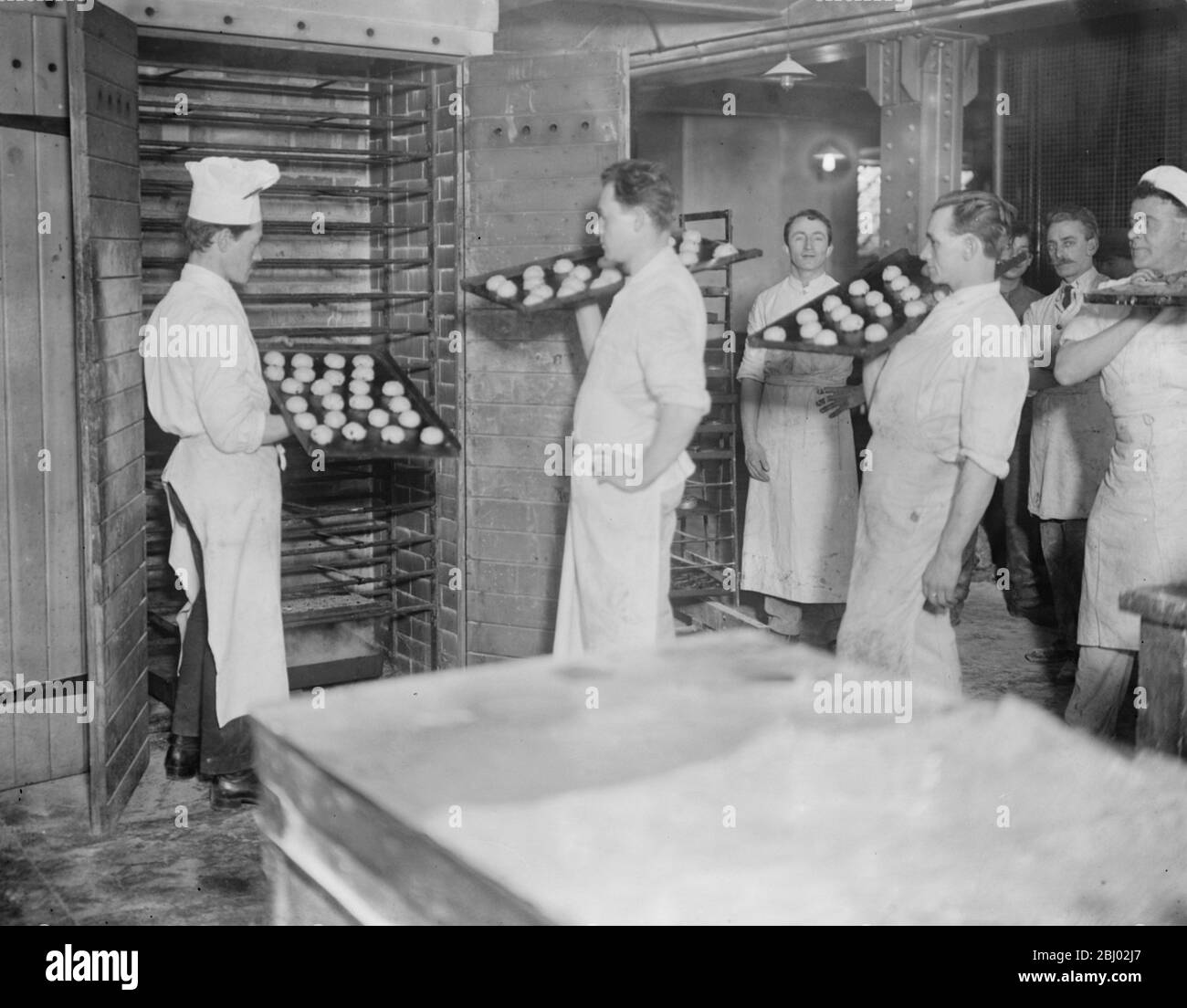 Die Herstellung von heißen Kreuzbrötchen bei R E Jones Ltd - in den Ofen - 28. März 1923 Stockfoto