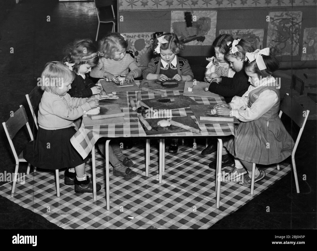 Kinder spielen in der neuen Kinderstube in Ricardo Street in Lansbury Poplar - die Nachbarschaft, die Teil des Festivals von Großbritannien Ausstellung der Architektur bildete. Es bietet Platz für 80 Kinder, kostet £17000 ist luftig bunt und hat alle modernen Annehmlichkeiten - 24. Januar 1952 Stockfoto