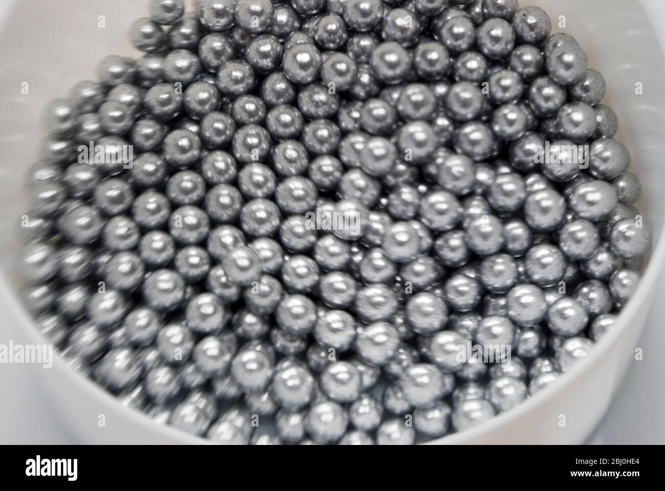 Essbare Silberkugeln für die Kuchendekoration, Aufnahme mit Lensbaby-Linse für unscharfen Rand-Effekt - Stockfoto
