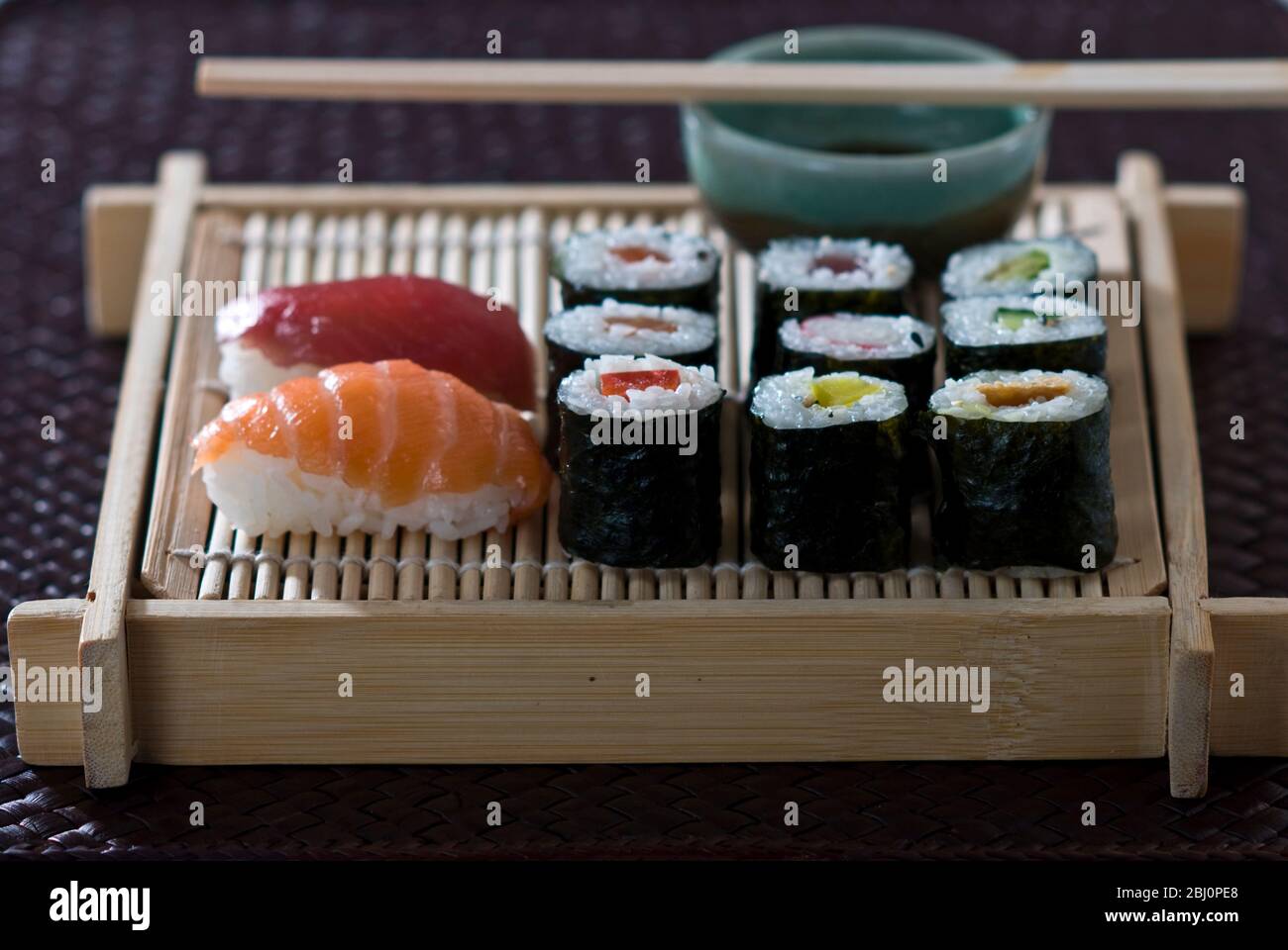 Sushi und Sashimi auf japanischem Bambusblech mit Sojasoße - Stockfoto