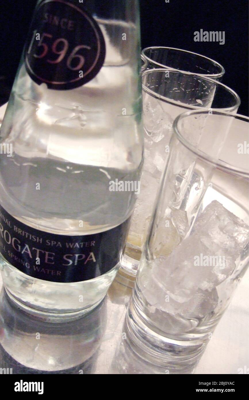 Glastablett mit Eis und Flasche Harrogate Spa Wasser - Stockfoto