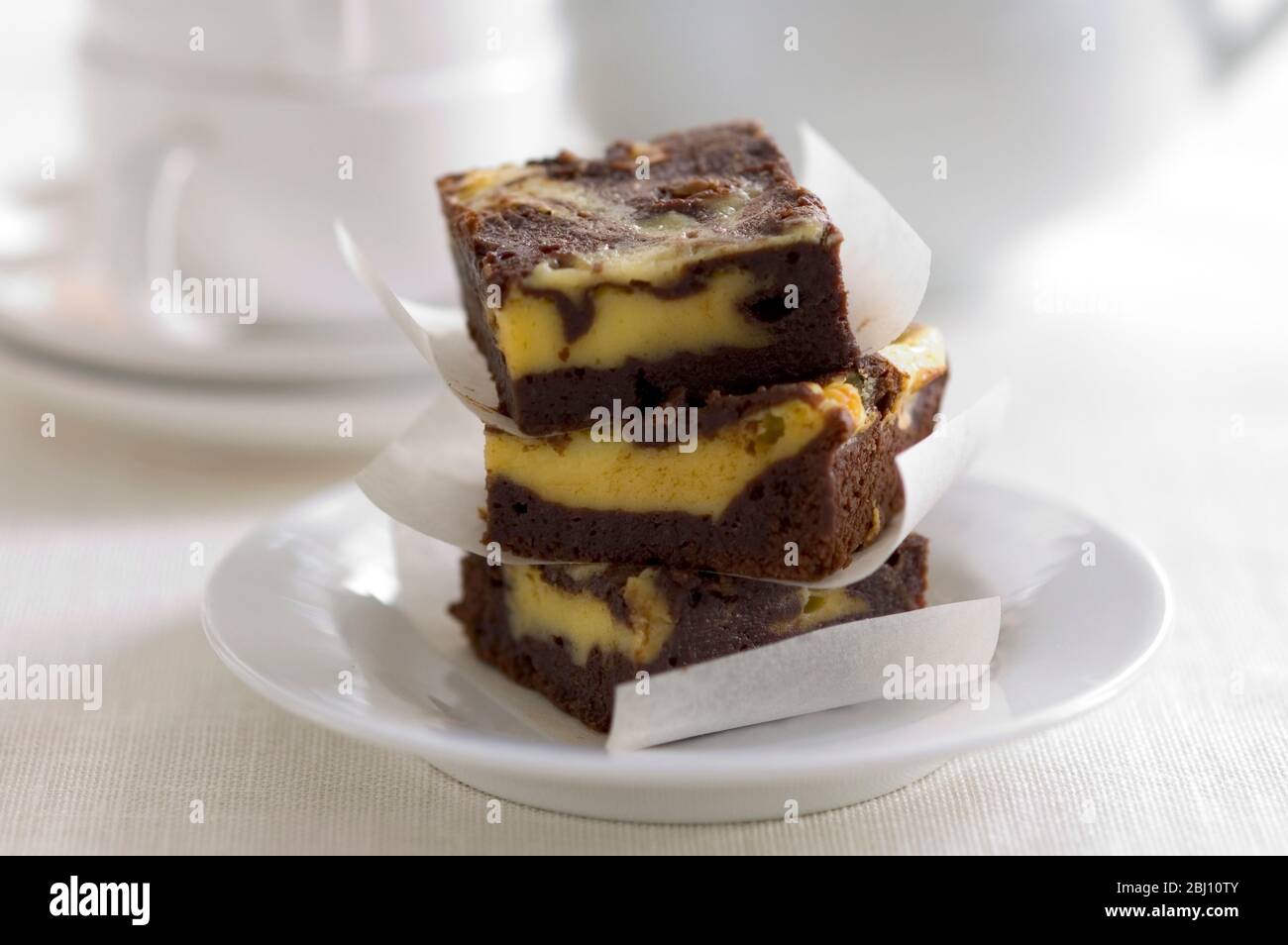 Gestapelte Quadrate von Käsekuchen marmoriert mit Schokolade - Stockfoto