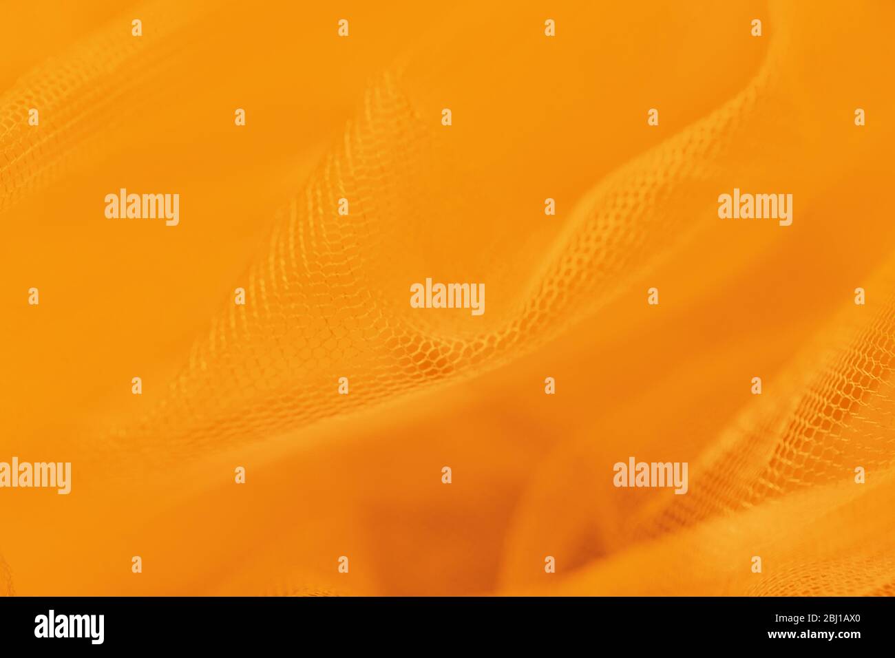 Kleine Netzware auf orangefarbenem Hintergrund. Schattierungen von Orange Farbe Stockfoto